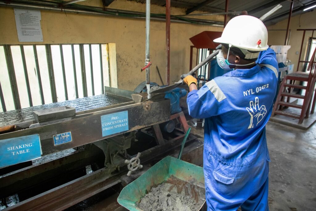 pexels photo 35082130 35082130 A factory worker in blue overalls operates a shaking table for ore processing.
